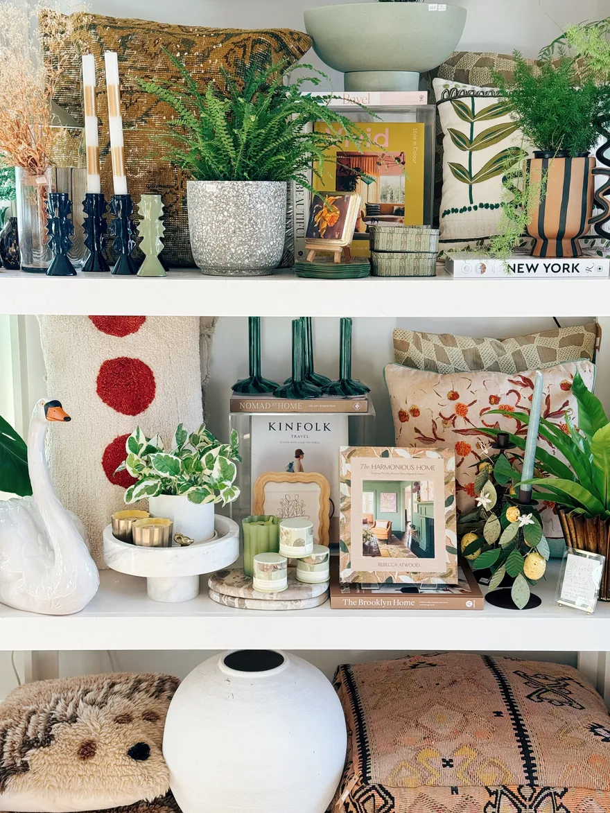 Layered kilim, polka-dot and floral pillows with a Moroccan pouf and coffee-table books.